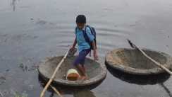 Flood Forces Two Brothers to Use Trough as Boat for School