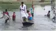 No Bridge Even in Death Villagers Carry Bier Across River